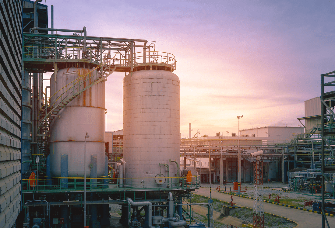 An oil refinery showcasing a complex network of equipment, pipes, and distillation towers using an ftir spectrometer to overcoming quality assurance issues and ensure refined oil products are free from impurities. 